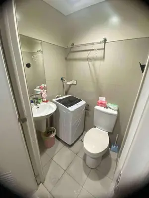 a small bathroom with a toilet and a sink at Ellein's Condotel in Manila