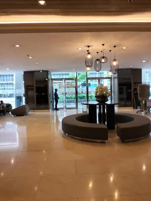 a lobby with a table in the middle of a building at Ellein's Condotel in Manila