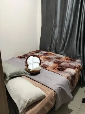 two beds with pillows on them in a room at Ellein's Condotel in Manila