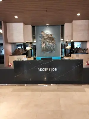 a reception area in a building with a sign at Ellein's Condotel in Manila