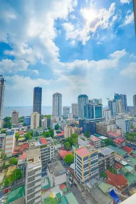 an aerial view of a city with tall buildings at Close by the airports and tourist attractions in Manila