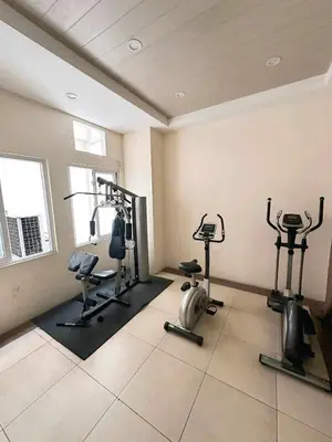 a gym with several tread machines in a room at Close by the airports and tourist attractions in Manila