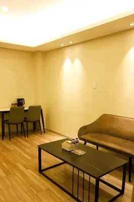 a living room with a couch and a table at Happy Holiday in Manila