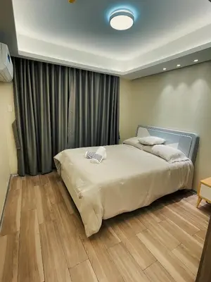 a bedroom with a large bed in front of a window at Happy Holiday in Manila