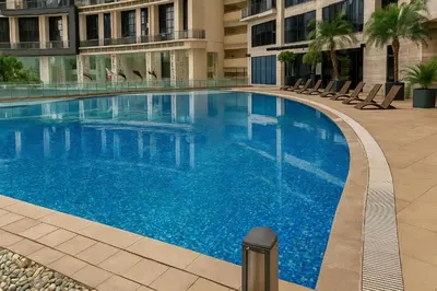 a large blue swimming pool in a building at The Spot 43 Sunrise in Makati in Manila