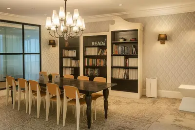 a dining room with a black table and chairs at The Spot 43 Sunrise in Makati in Manila