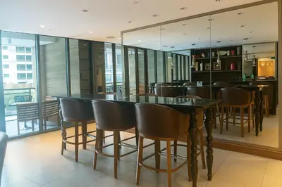 a dining room with a table and chairs at The Spot 43 Sunrise in Makati in Manila