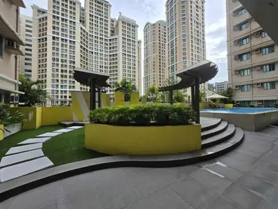 a courtyard in a city with tall buildings at SMDC Shine Residence in Manila