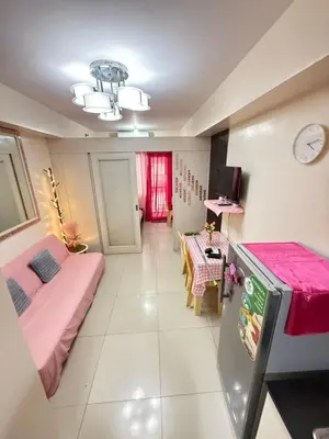 a room with two beds and a table at R&K Staycation in Manila