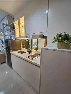 a kitchen with white cabinets and a counter with plants at Stylish and Glamours Haven in Manila
