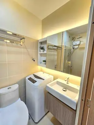 a bathroom with a toilet and a sink at Stylish and Glamours Haven in Manila