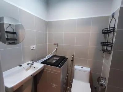 a bathroom with a white toilet and a sink at Manila Bay Coast Residences 1BR Flat in Manila