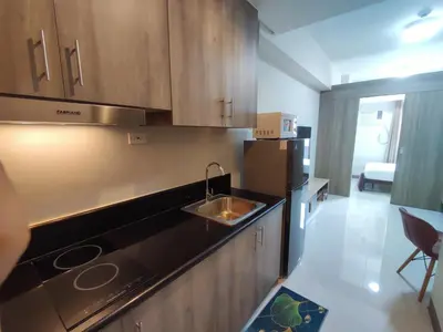 a kitchen with a sink and a stove at Manila Bay Coast Residences 1BR Flat in Manila