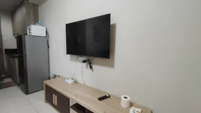a living room with a tv on the wall at Manila Bay Coast Residences 1BR Flat in Manila