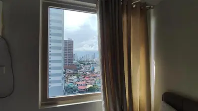 a window with a view of a city at Manila Bay Coast Residences 1BR Flat in Manila