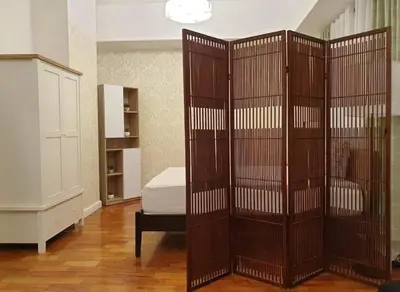 a large cage with a bed in a room at Spacious Studio no balcony in Mosaic Tower with WiFi and Smart TV in Manila