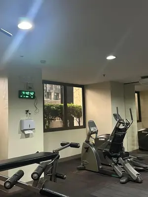 a gym with treadmills and elliptical machines at Spacious Studio no balcony in Mosaic Tower with WiFi and Smart TV in Manila