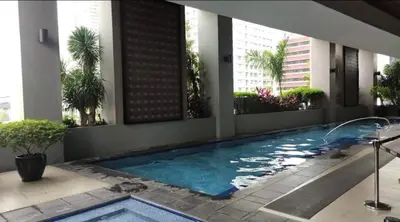 a swimming pool in the middle of a building at Spacious Studio no balcony in Mosaic Tower with WiFi and Smart TV in Manila