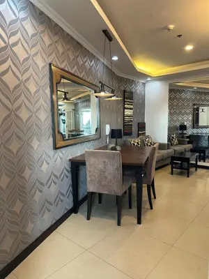a dining room with a table and a mirror at Sunset View 1 BR with balcony FREE Pool&Gym Access in Manila
