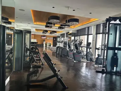a gym with a lot of treadmills and machines at Sunset View 1 BR with balcony FREE Pool&Gym Access in Manila