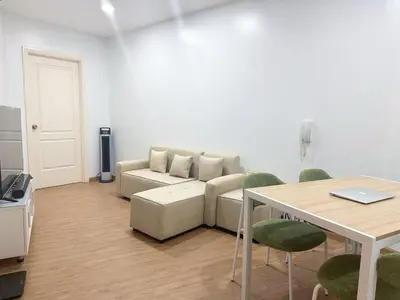 a living room with a couch and a table at Minimalist 1 Bedroom Sunset View in Gramercy in Manila