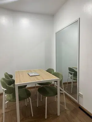 a conference room with a table and green chairs at Minimalist 1 Bedroom Sunset View in Gramercy in Manila