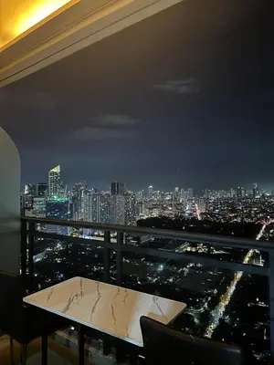 a room with a view of a city at night at Minimalist 1 Bedroom Sunset View in Gramercy in Manila