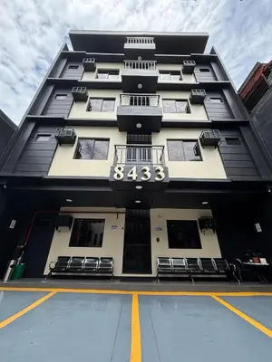 a black and white building with a number on it at The Budget Inn in Manila