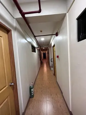 a hallway in an office building with a long corridor at The Budget Inn in Manila