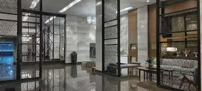 a lobby of a building with glass doors and a table at Cooper's Place in Manila