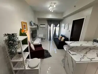 a living room with a couch and a table at Cooper's Place in Manila