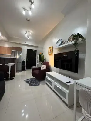 a living room with a couch and a tv at Cooper's Place in Manila