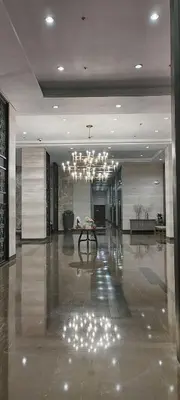 a large lobby with a chandelier in a building at Cooper's Place in Manila