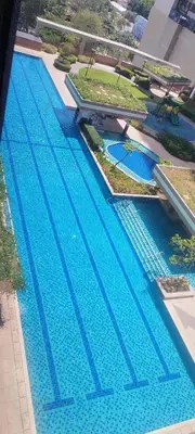 an overhead view of a large blue swimming pool at Cooper's Place in Manila