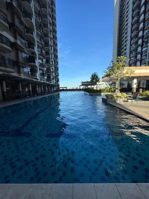 a swimming pool in the middle of two tall buildings at Cooper's Place in Manila