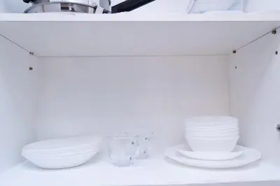 a shelf with white bowls and plates on it at CABIN STUDIO in KL TOWER, Greenbelt, Makati! Max Capacity 6 pax! in Manila