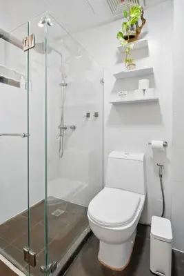 a white bathroom with a toilet and a shower at CABIN STUDIO in KL TOWER, Greenbelt, Makati! Max Capacity 6 pax! in Manila