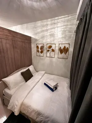 a bedroom with a bed with two books on it at Shore2 Residence Pasay by N&R Valmont in Manila