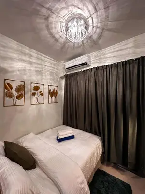 a bedroom with two beds with a book on top at Shore2 Residence Pasay by N&R Valmont in Manila
