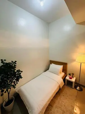 a bedroom with a bed and a potted plant at Shore2 Residence Pasay by N&R Valmont in Manila