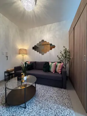 a living room with a couch and a table at Shore2 Residence Pasay by N&R Valmont in Manila