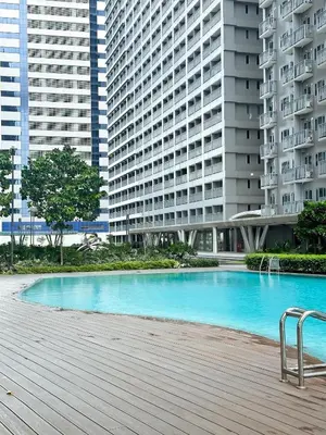 a large swimming pool in front of some tall buildings at Stylish City Escape in Manila