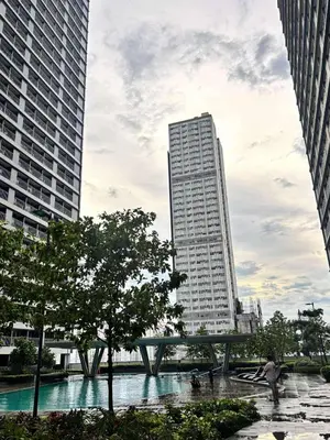 a tall building in the middle of a city at Stylish City Escape in Manila