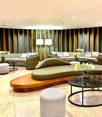 a living room with couches and tables and chairs at Chic City Escape by the Bay in Manila