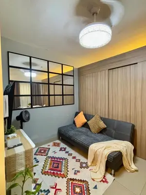 a living room with a couch and a rug at Chic City Escape by the Bay in Manila
