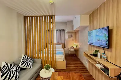 a small room with a bed and a tv in it at 1BR Condotel Ridgewood Towers Near BGC Airport #RW17 in Manila