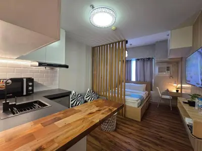 a room with a kitchen and a living room with a couch at 1BR Condotel Ridgewood Towers Near BGC Airport #RW17 in Manila