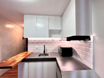 a kitchen with white cabinets and a counter top at 1BR Condotel Ridgewood Towers Near BGC Airport #RW17 in Manila