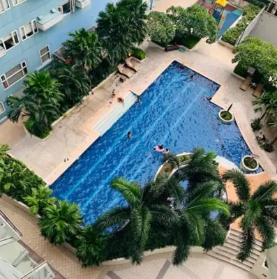 an overhead view of a large swimming pool with palm trees at 1BR Condotel Ridgewood Towers Near BGC Airport #RW17 in Manila