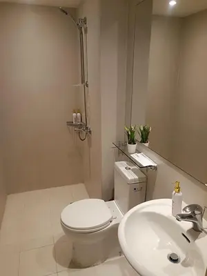 a white bathroom with a toilet and a sink at Azure Urban Resort Staycation in Manila